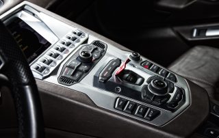 A grey, sleek, luxury cockpit console of an impressive supercar.