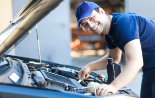 A mechanic services a car engine