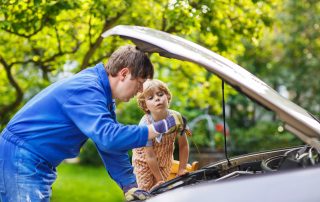 Father teaching son car care