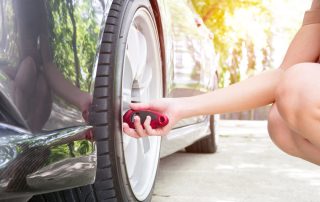 women checking tire pressure