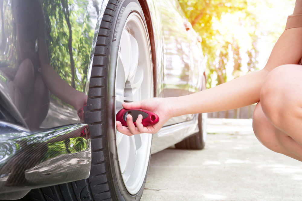 women checking tire pressure