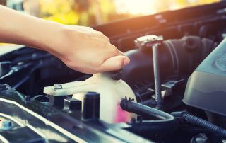 Changing car fluids to avoid future auto repair