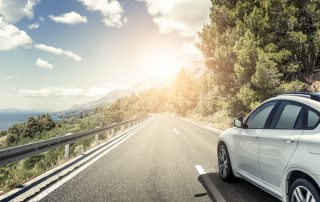 Car driving around a mountain bend