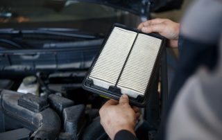 replacement of car air filter by auto mechanic