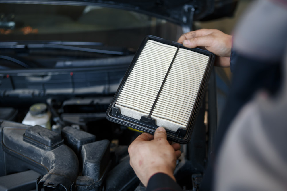 replacement of car air filter by auto mechanic