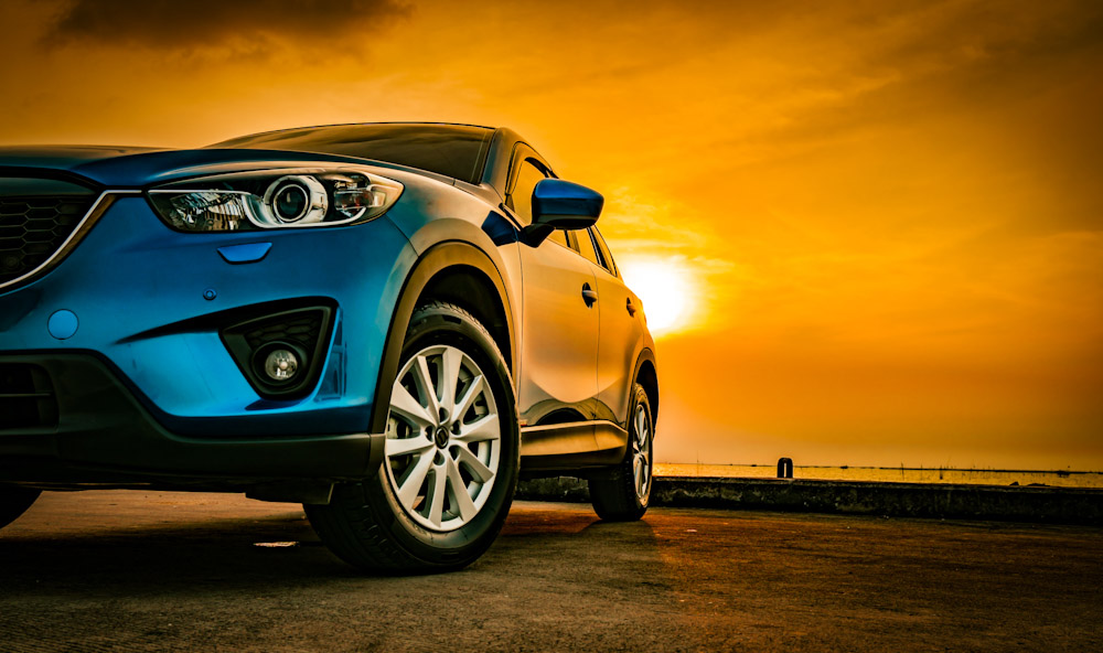 Blue compact SUV car with sport and modern design parked on concrete