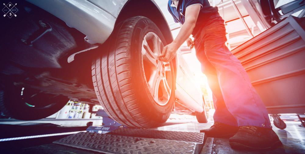 Mechanic performing car repair on a vehicle