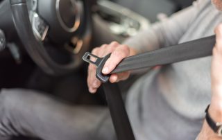 Man putting on seat belt