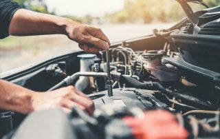 Auto mechanic working in garage Technician Hands of car mechanic