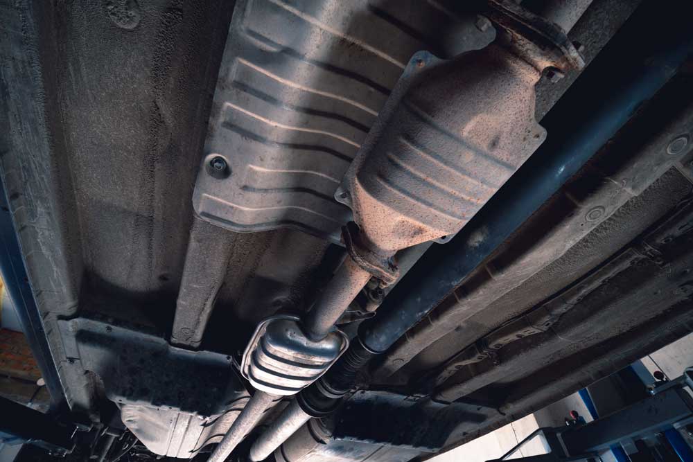 Catalytic converter on vintage vehicle. Old parts require car repair concept.