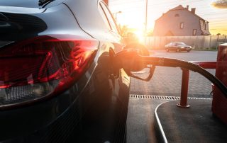 Refueling car. Pump gas at petrol fuel station. Gasoline oil nozzle tank from hand person. Automotive industry or transportation concept.