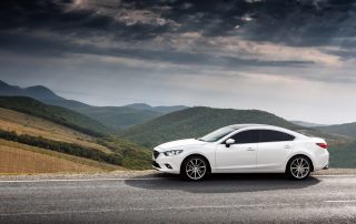 new car parked on mountain road