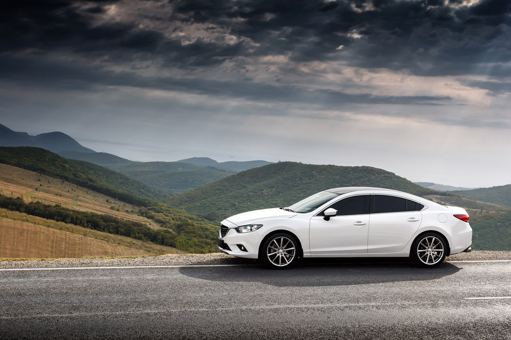 new car parked on mountain road