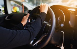 woman moving steering wheel. power steering concept.