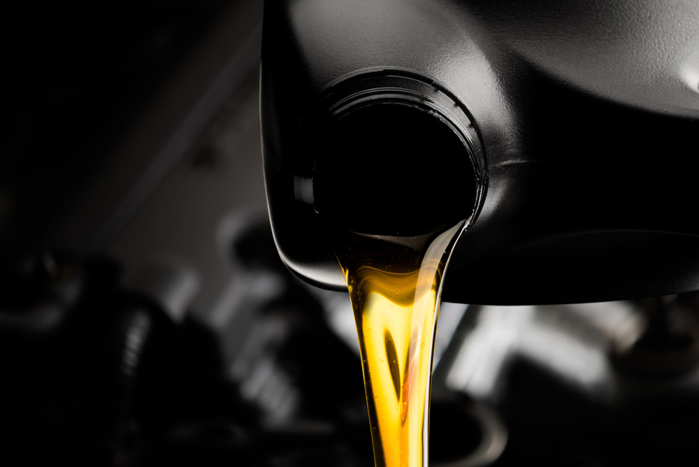 motor oil being poured into engine. oil change concept