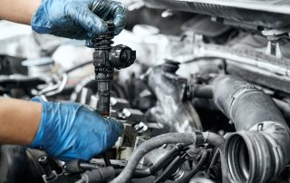 auto technician replacing ignition coil in vehicle