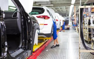 Cars being made on an assembly line.