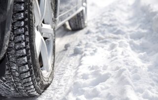 Close up of car wheel in the snow.