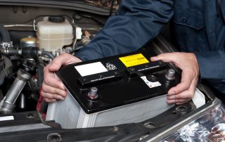 mechanic replacing car battery
