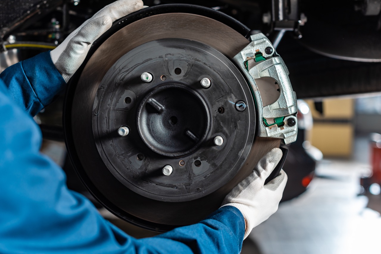 mechanic changing brakes in garage