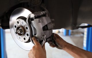 mechanic changing car brakes