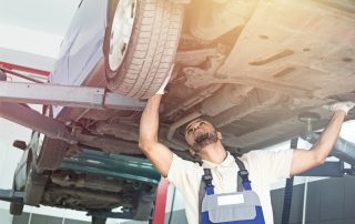 mechanic checking car's catalytic converter