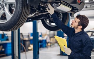 mechanic inspecting car for repairs