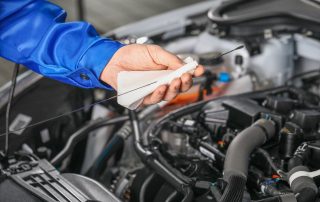 mechanic checks oil level