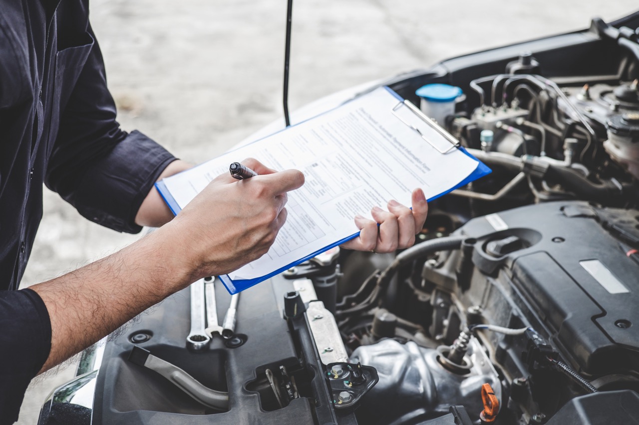 man checks car to-do list