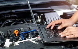 mechanic checking engine diagnostics