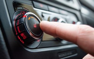 person turning car heater on