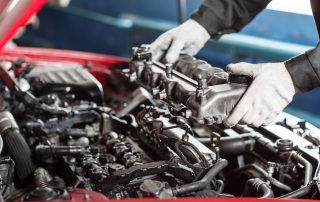 mechanic inspects engine for repair