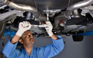 mechanic repairs car exhaust