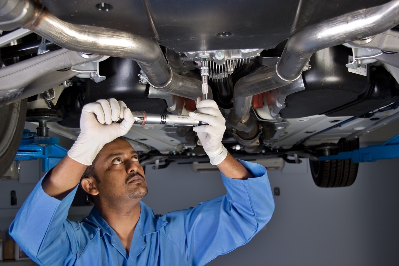 mechanic repairs car exhaust