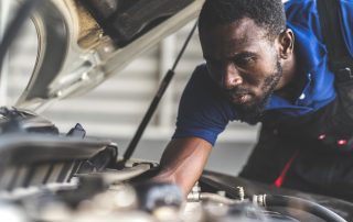 mechanic tuning up car