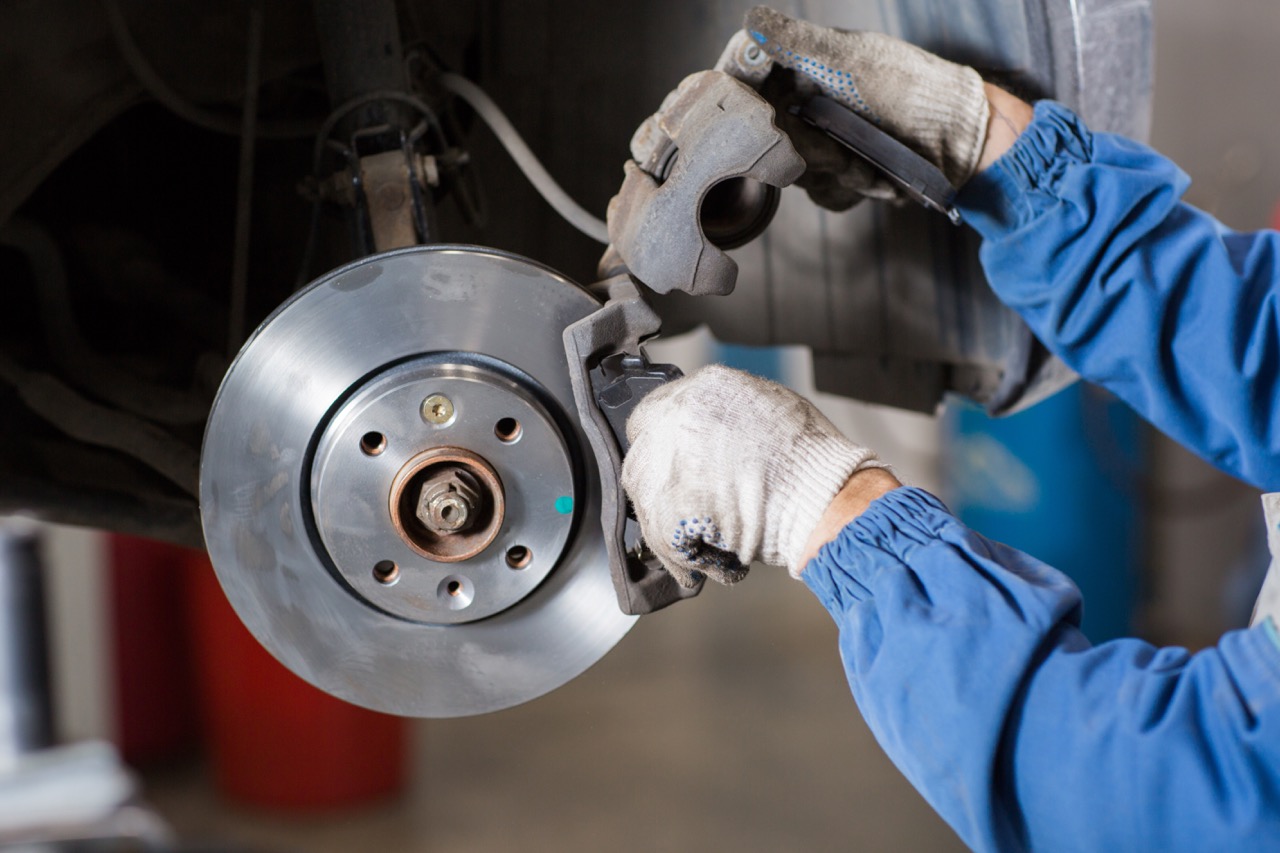 mechanic changing brake rotor