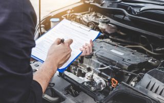mechanic with car maintenance checklist