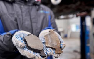 mechanic holding brake pads
