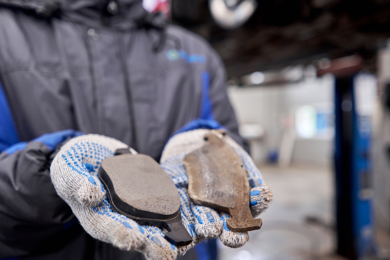 mechanic holding brake pads