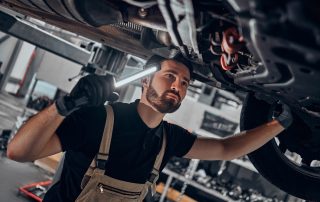 mechanic fixing under car