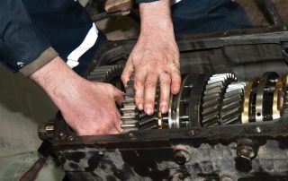 mechanic repairing transmission