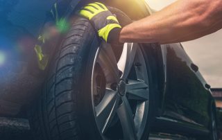 mechanic rotates tires of car