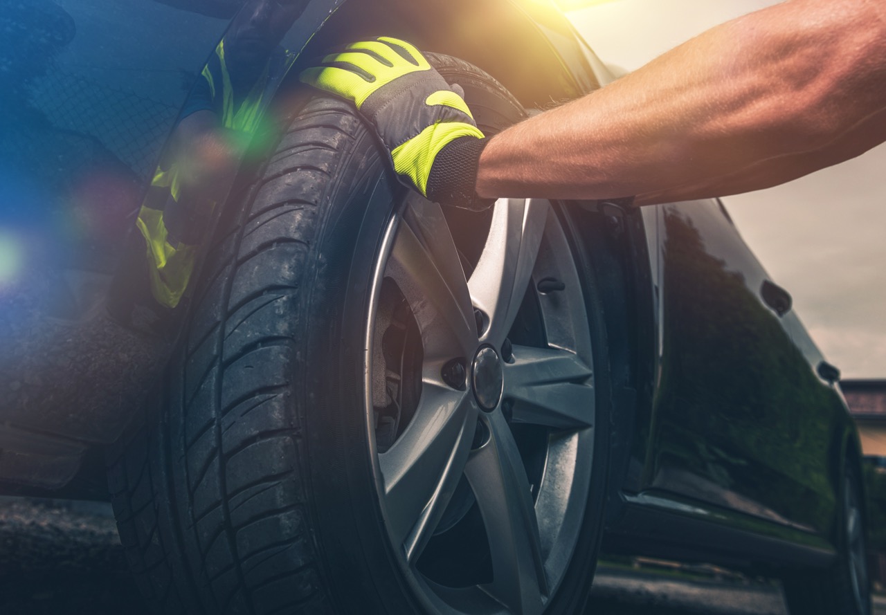 mechanic rotates tires of car