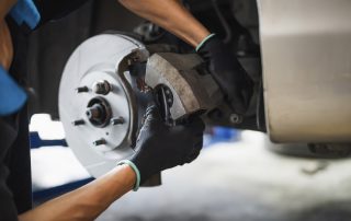 mechanic changing brake rotor