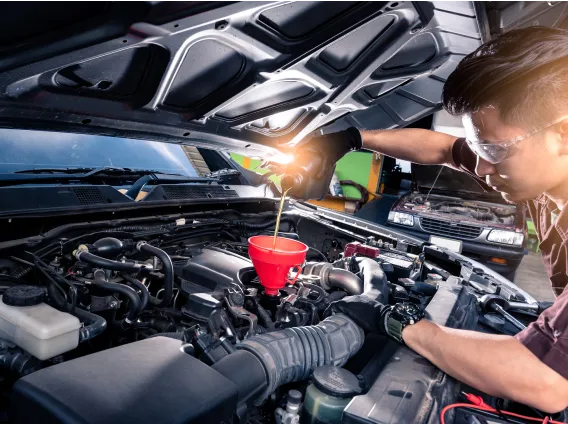 Technician performing an oil change