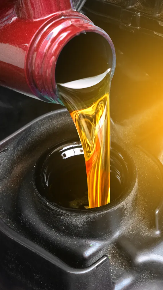 Oil pouring into a car's engine.